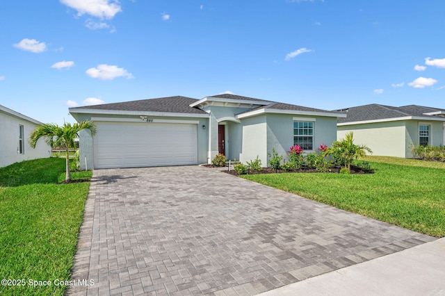 view of front facade with a garage, a front yard, decorative driveway, and stucco siding