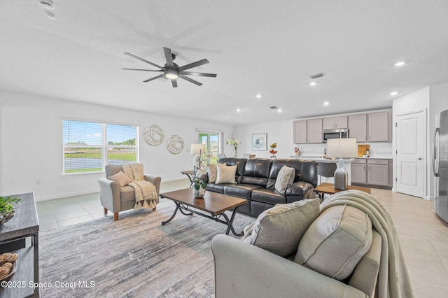 living room with ceiling fan, light tile patterned flooring, recessed lighting, visible vents, and baseboards