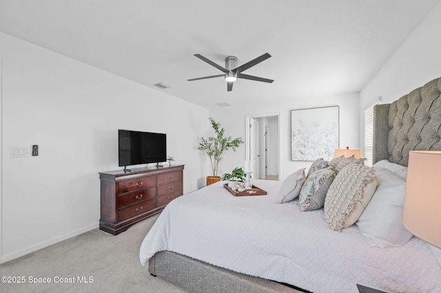 bedroom with light carpet, ceiling fan, visible vents, and baseboards