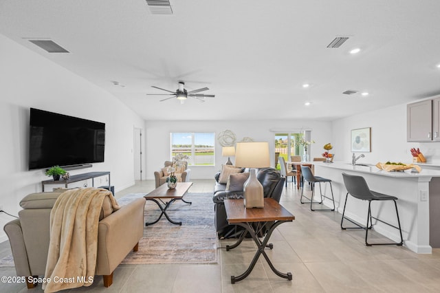 living room featuring a ceiling fan, recessed lighting, and visible vents