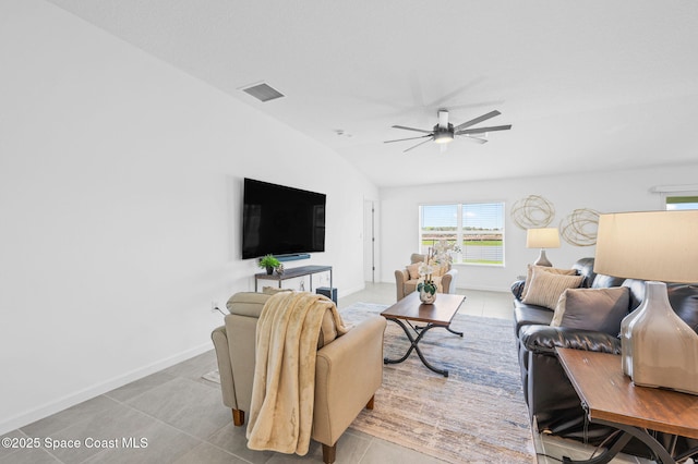 living area with light tile patterned floors, lofted ceiling, visible vents, a ceiling fan, and baseboards