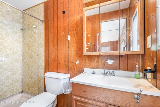 bathroom featuring toilet, wood walls, a shower, and vanity