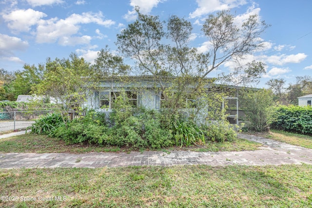 view of front of property with fence and a front lawn