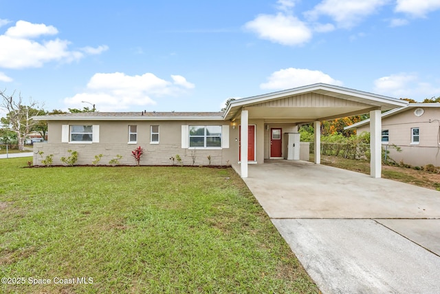 ranch-style house with concrete driveway, an attached carport, fence, a front yard, and brick siding