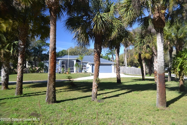 view of yard featuring a garage and fence