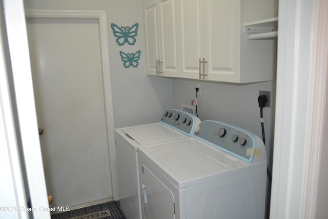 washroom with washer and dryer and cabinet space