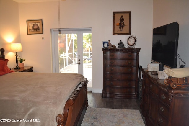 bedroom featuring french doors, dark wood finished floors, and access to outside