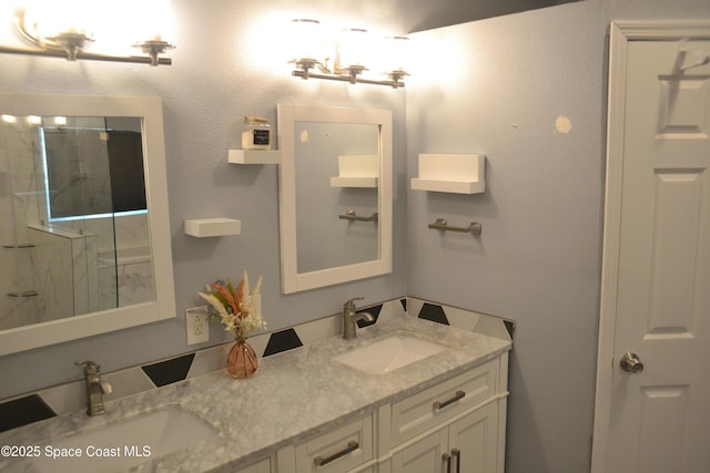 full bath featuring double vanity, a shower, and a sink