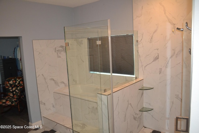 bathroom featuring a marble finish shower