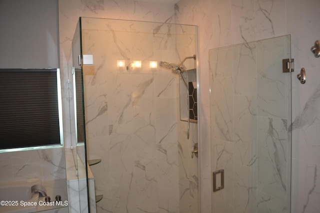 bathroom featuring a marble finish shower and a bathtub