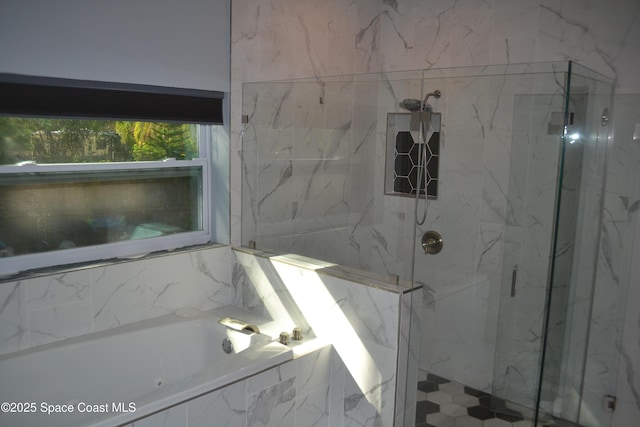 full bath featuring a marble finish shower and a garden tub