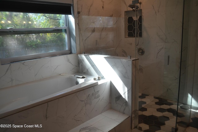 full bath featuring a garden tub and a marble finish shower