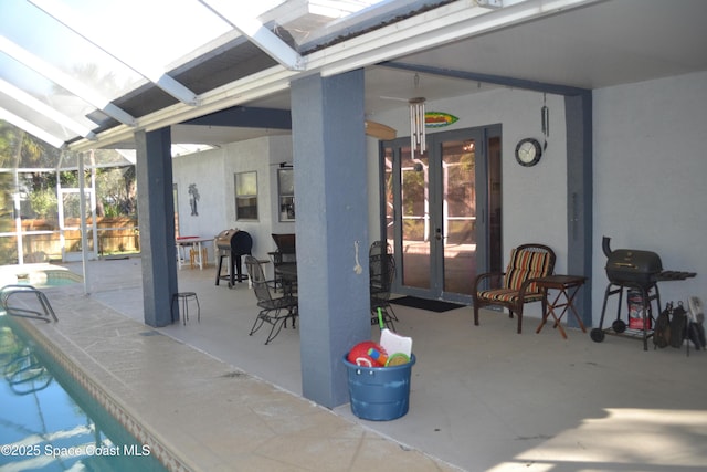 view of patio featuring an outdoor pool, french doors, grilling area, and glass enclosure