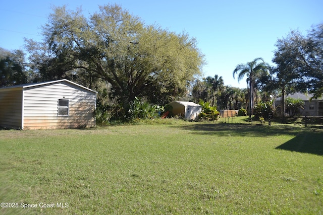 view of yard featuring an outdoor structure and a shed