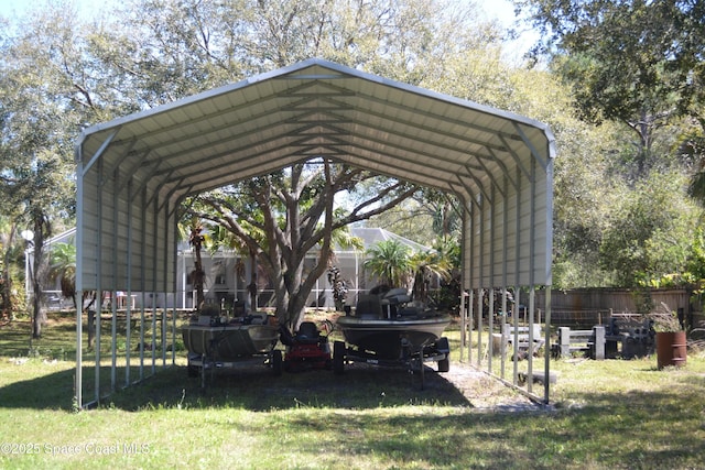 view of parking / parking lot with a detached carport and fence