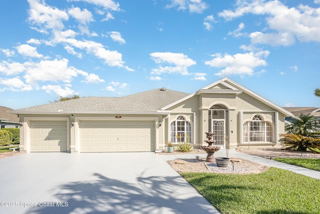 ranch-style house with concrete driveway, roof with shingles, an attached garage, and stucco siding