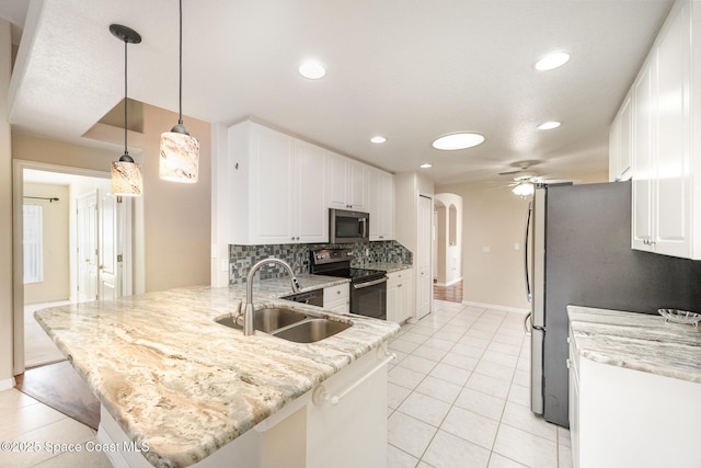 kitchen featuring appliances with stainless steel finishes, a peninsula, hanging light fixtures, white cabinetry, and a sink