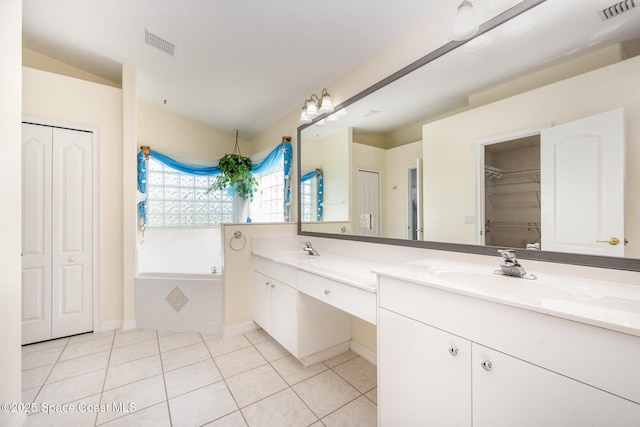 full bathroom featuring double vanity, a closet, tile patterned flooring, and visible vents