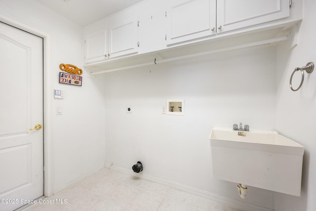 laundry area with washer hookup, a sink, cabinet space, and baseboards