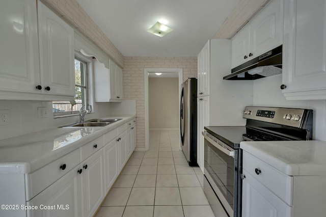 kitchen featuring white cabinets, under cabinet range hood, stainless steel appliances, and a sink