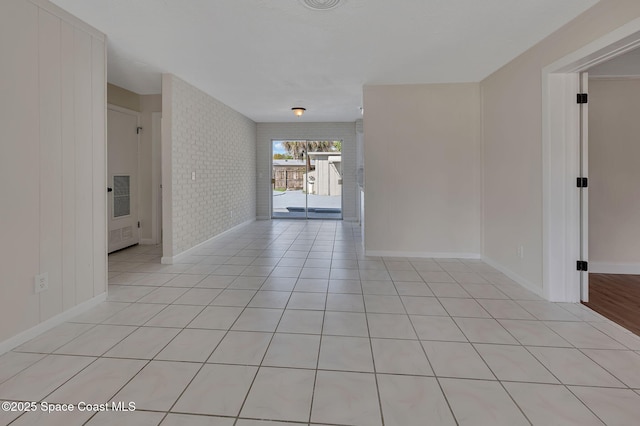 unfurnished room with light tile patterned floors, baseboards, and visible vents