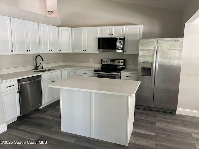 kitchen featuring appliances with stainless steel finishes, light countertops, white cabinets, and a sink