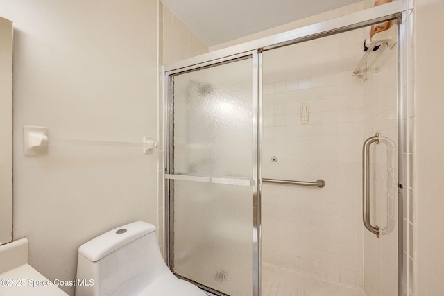 bathroom with tiled shower and toilet