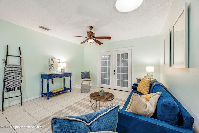 living area with baseboards, visible vents, a textured ceiling, french doors, and light tile patterned flooring