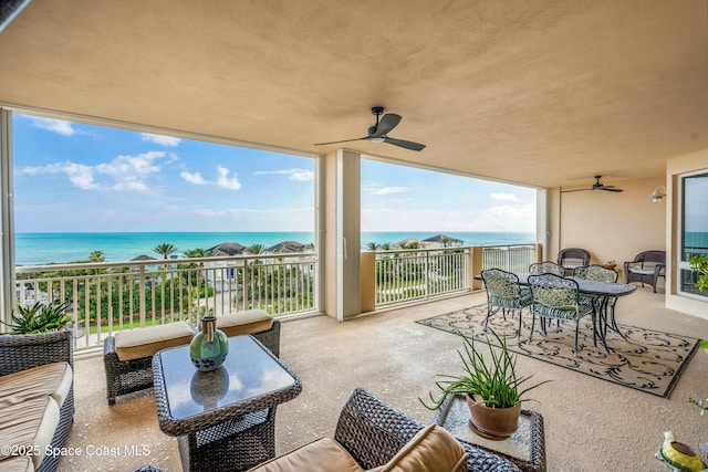 balcony with a ceiling fan, outdoor dining area, a water view, and an outdoor living space