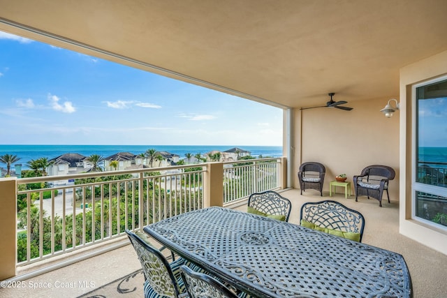 balcony with ceiling fan, outdoor dining space, a water view, and a sunroom