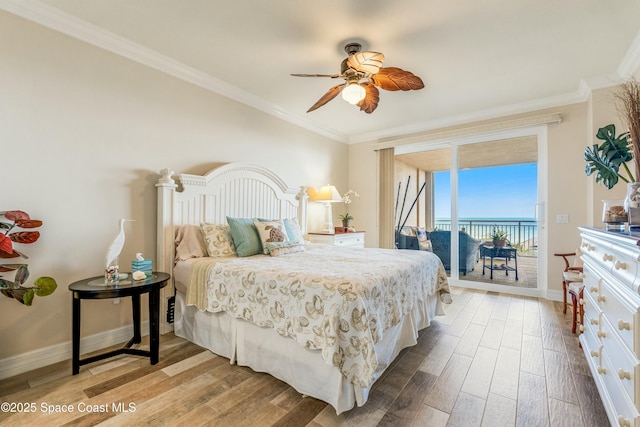 bedroom with baseboards, ornamental molding, wood finished floors, and access to exterior