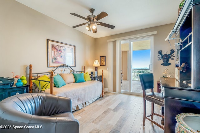 bedroom featuring light wood-style floors, a ceiling fan, and access to exterior