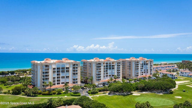 drone / aerial view featuring view of golf course and a water view