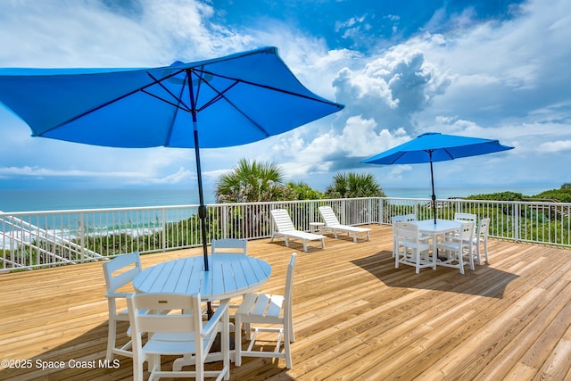 wooden terrace featuring a water view