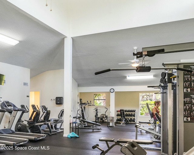 exercise room with a healthy amount of sunlight, visible vents, and a textured ceiling