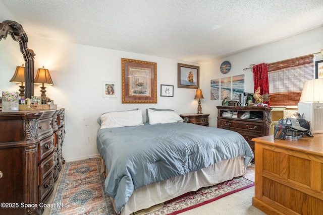 bedroom featuring carpet floors and a textured ceiling