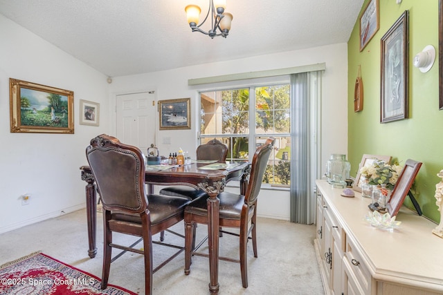 dining space featuring light carpet, an inviting chandelier, baseboards, and a textured ceiling