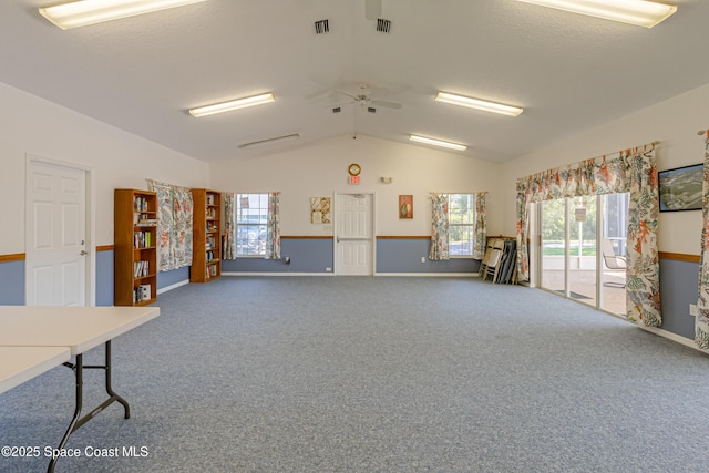 misc room featuring lofted ceiling, plenty of natural light, visible vents, and carpet flooring