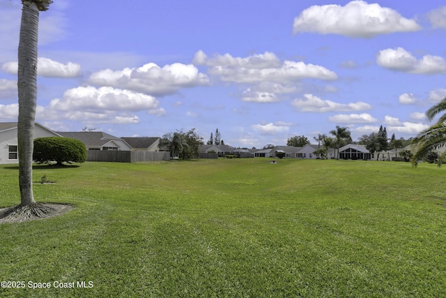 view of yard with a residential view and fence