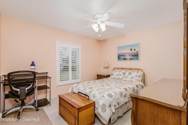 bedroom featuring baseboards, a ceiling fan, and light colored carpet