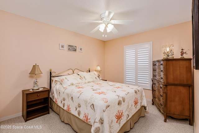 bedroom featuring light carpet, baseboards, and a ceiling fan