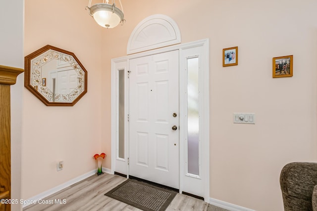 foyer entrance featuring light wood-style flooring and baseboards