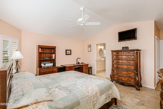 bedroom with vaulted ceiling, a ceiling fan, and ensuite bathroom