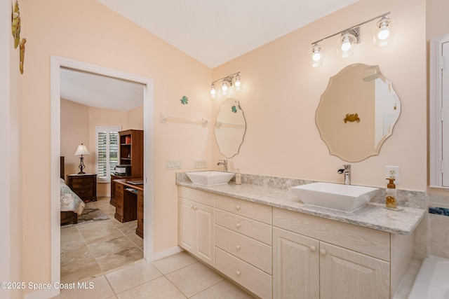 bathroom with double vanity, tile patterned flooring, connected bathroom, and a sink