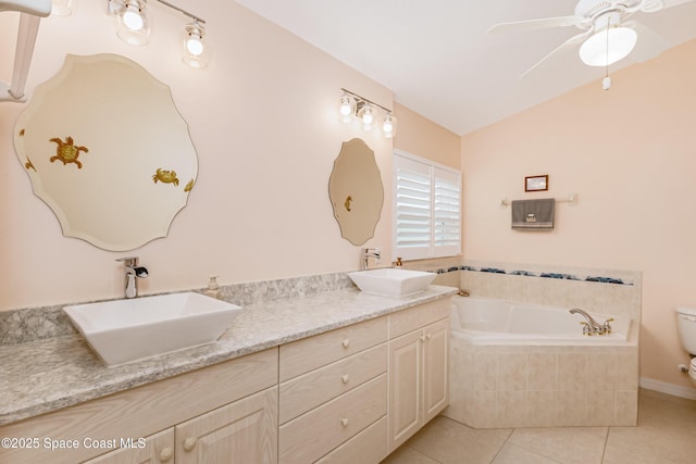 full bathroom with a garden tub, a sink, toilet, and tile patterned floors