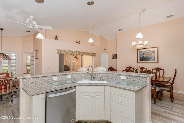 kitchen featuring lofted ceiling, light wood-style flooring, a sink, white cabinets, and stainless steel dishwasher