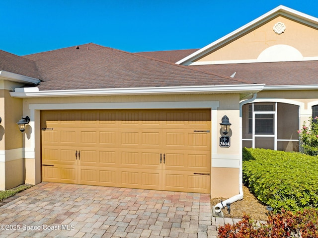 garage with decorative driveway