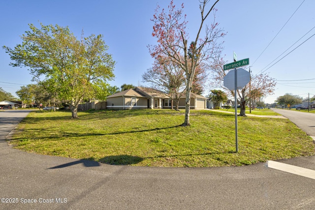 view of front of house featuring a front lawn and fence