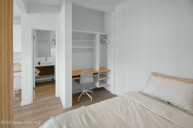 bedroom with a closet and wood finished floors