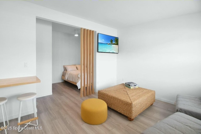 bedroom featuring baseboards and wood finished floors